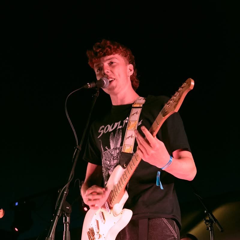Emiel V. singing and playing rhythm guitar