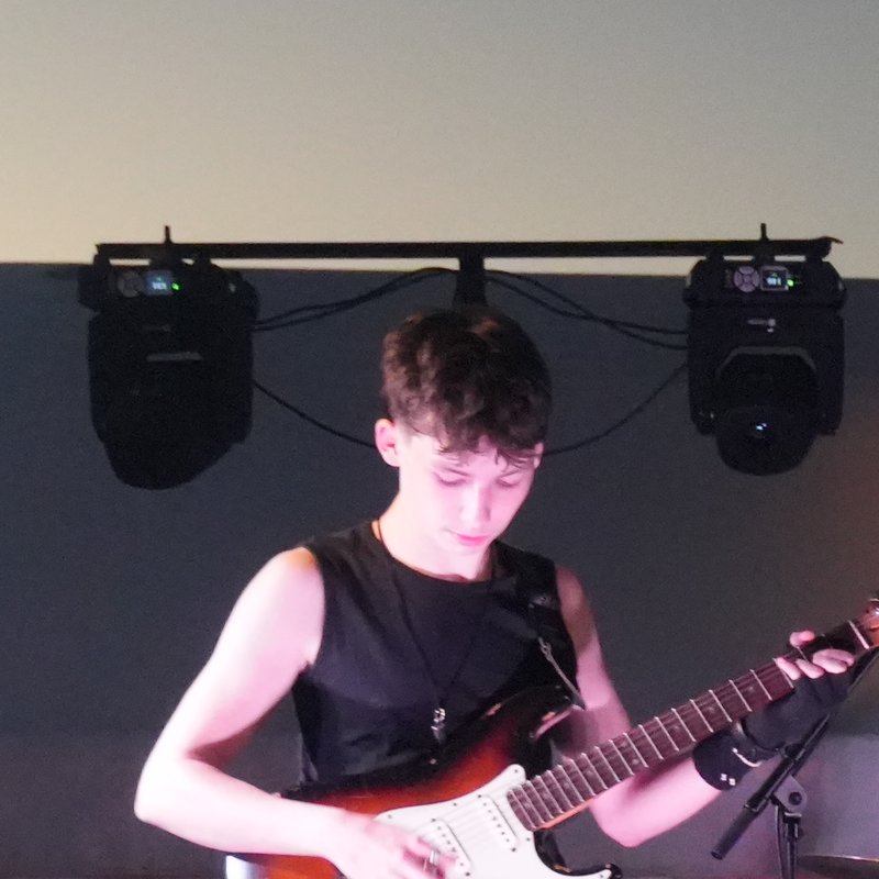 Maurice V. playing lead guitar