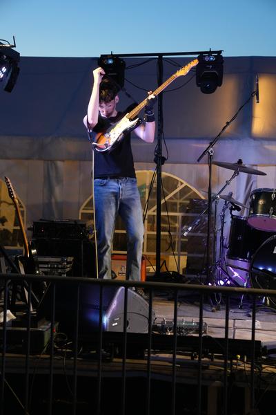 Guitarist mid-jump on stage