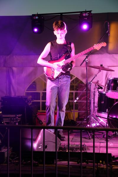 Guitarist under purple stage lights